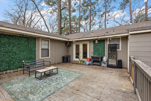 exterior space with a wooden deck and french doors