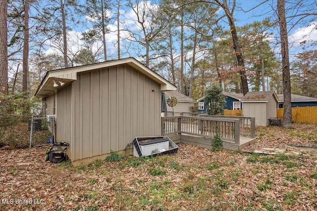 view of side of property with a shed and a deck