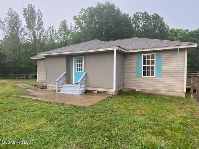 rear view of property featuring a patio, crawl space, a yard, entry steps, and fence