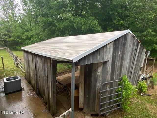 view of outbuilding featuring central AC and an outbuilding