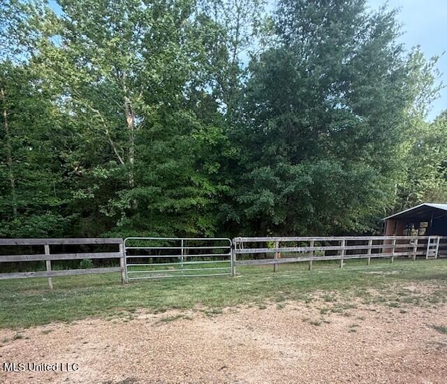 view of yard with fence and an outbuilding
