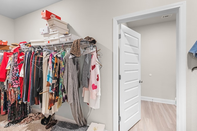 spacious closet featuring light hardwood / wood-style floors