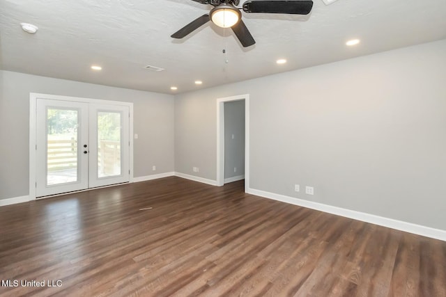 empty room featuring recessed lighting, baseboards, dark wood-style flooring, and french doors