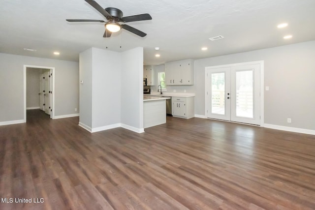 unfurnished living room with french doors, recessed lighting, dark wood finished floors, and baseboards