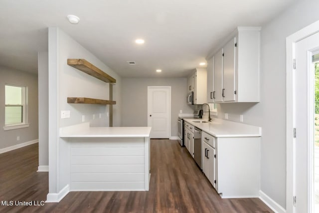 kitchen featuring dark wood-style flooring, open shelves, stainless steel appliances, light countertops, and white cabinets