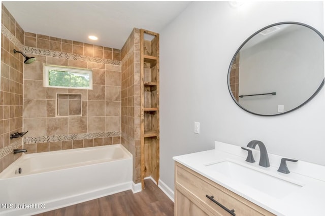 full bath with vanity, baseboards, wood finished floors, and bathing tub / shower combination