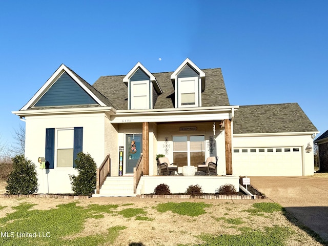 cape cod-style house featuring driveway and a garage