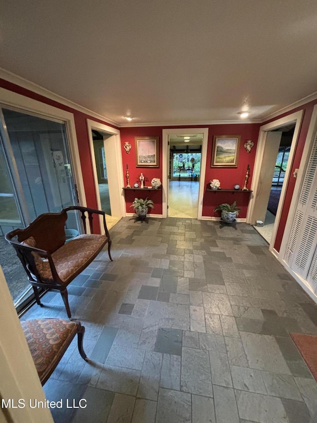 hall featuring crown molding, recessed lighting, stone tile flooring, and baseboards