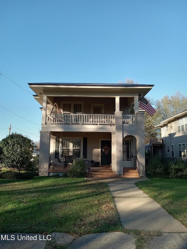 107 E Percy St, Indianola, MS 38751 - view of front facade with a balcony, a front yard, brick siding, and covered porch