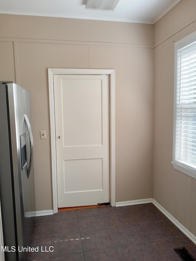 107 E Percy St, Indianola, MS 38751 - empty room featuring baseboards and dark tile patterned floors