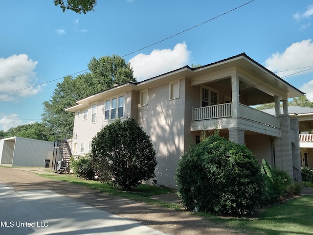107 E Percy St, Indianola, MS 38751 - view of home's exterior featuring stucco siding and a balcony