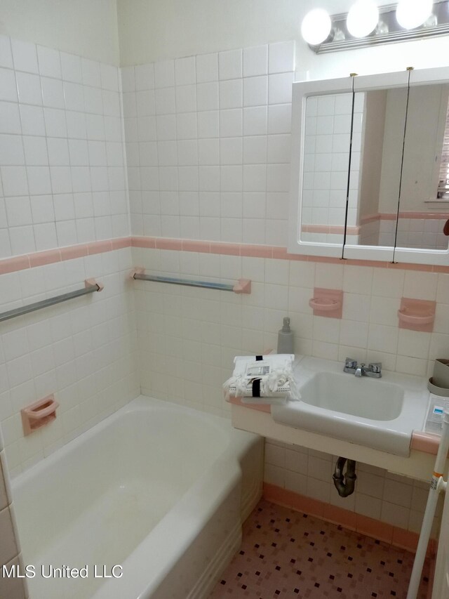107 E Percy St, Indianola, MS 38751 - bathroom featuring tile walls and a bathtub