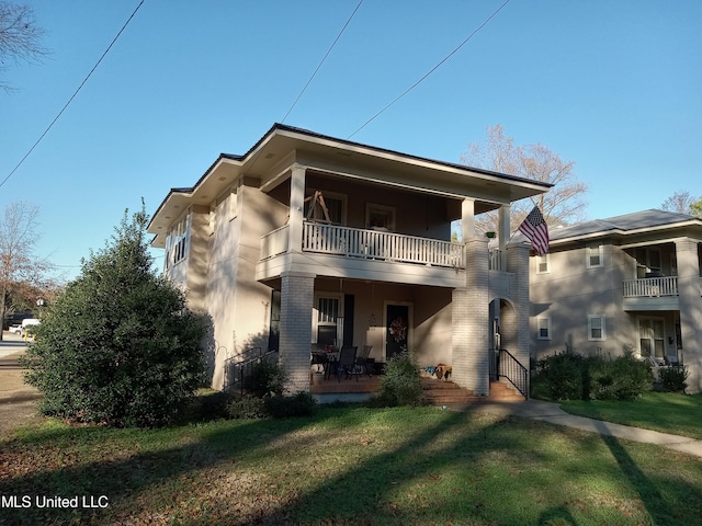 107 E Percy St, Indianola, MS 38751 - rear view of property with a balcony, a lawn, brick siding, and stucco siding