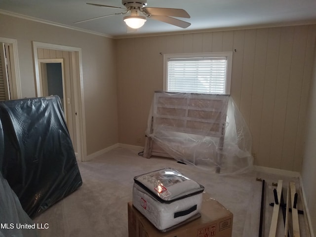 107 E Percy St, Indianola, MS 38751 - unfurnished room with light carpet, a ceiling fan, ornamental molding, baseboards, and wooden walls