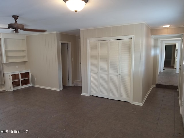 107 E Percy St, Indianola, MS 38751 - unfurnished living room featuring crown molding, ceiling fan, and baseboards