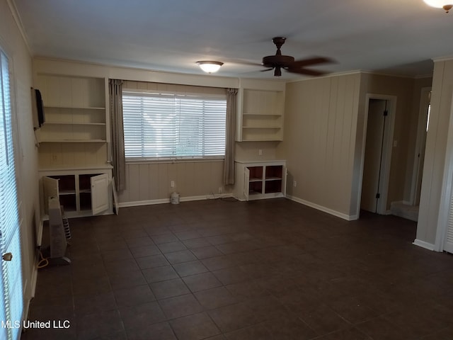 107 E Percy St, Indianola, MS 38751 - unfurnished living room with a ceiling fan, ornamental molding, baseboards, and dark tile patterned flooring