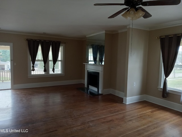 107 E Percy St, Indianola, MS 38751 - unfurnished living room featuring dark wood finished floors, ceiling fan, baseboards, ornamental molding, and a fireplace with flush hearth