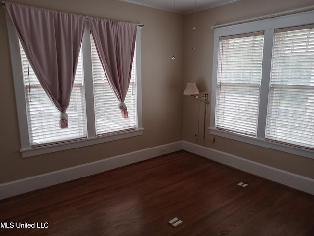 107 E Percy St, Indianola, MS 38751 - spare room with wood finished floors, baseboards, and healthy amount of natural light