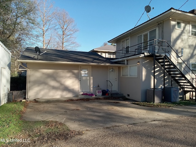 107 E Percy St, Indianola, MS 38751 - view of front of house with stucco siding, cooling unit, and stairway