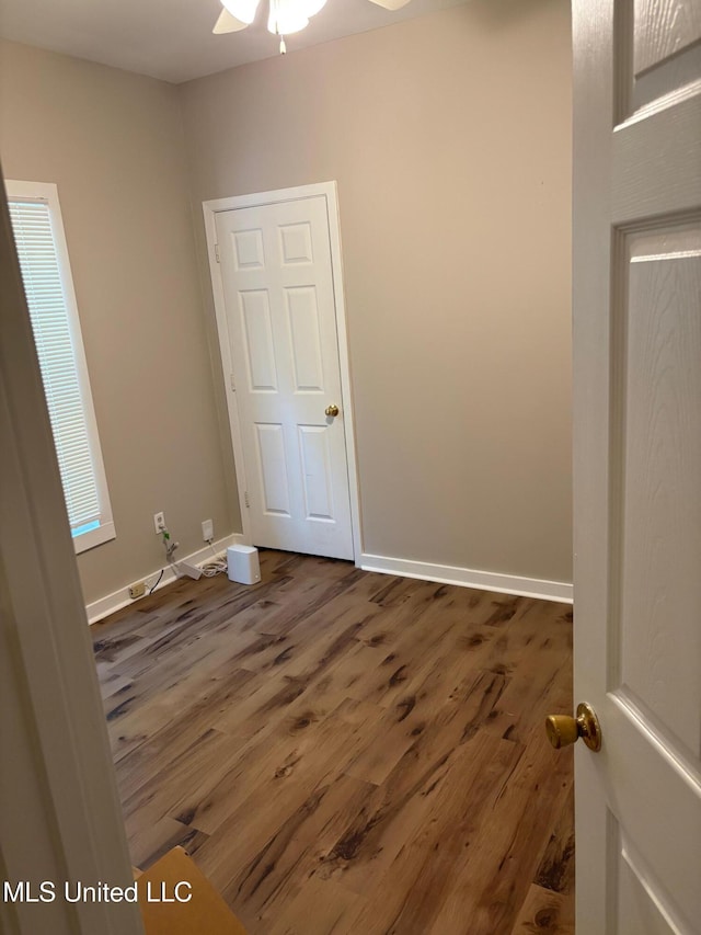 unfurnished bedroom with baseboards and wood finished floors