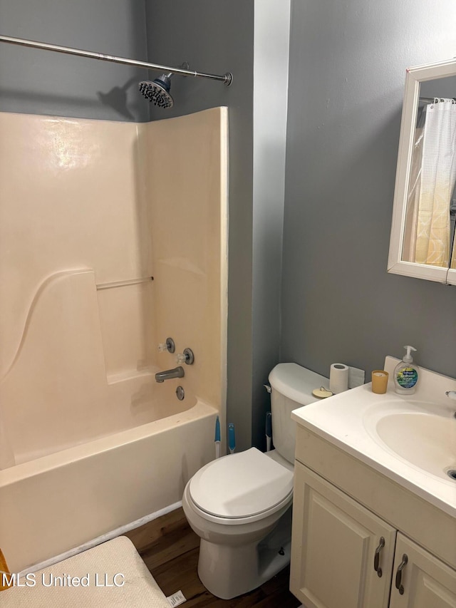 full bath with toilet, shower / bathtub combination with curtain, wood finished floors, and vanity