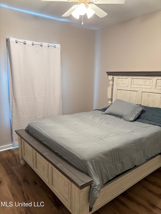 bedroom featuring ceiling fan and dark wood-type flooring