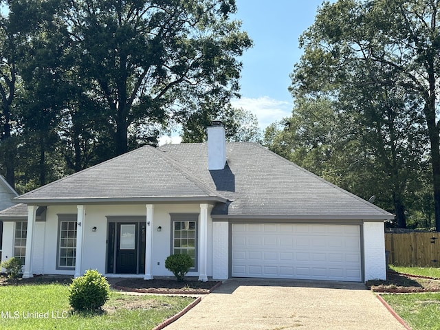 124 Holmar Dr, Brandon, MS 39047 - single story home featuring driveway, an attached garage, a chimney, and roof with shingles