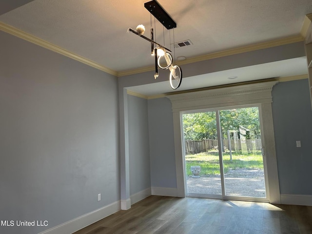 124 Holmar Dr, Brandon, MS 39047 - unfurnished room with baseboards, wood finished floors, crown molding, and a chandelier
