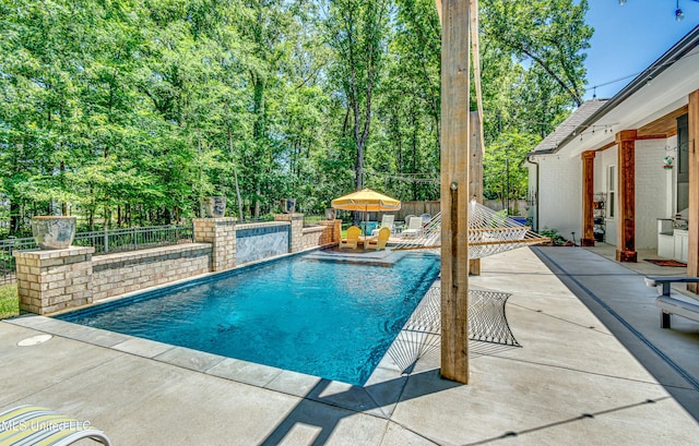 102 Silverleaf Dr, Madison, MS 39110 - swimming pool featuring a patio area, a fenced backyard, and view of scattered trees