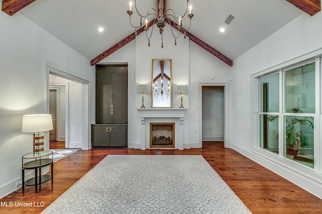 102 Silverleaf Dr, Madison, MS 39110 - living area with beamed ceiling, a chandelier, a large fireplace, high vaulted ceiling, and dark wood-style flooring