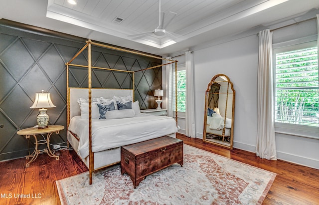 102 Silverleaf Dr, Madison, MS 39110 - bedroom featuring wood finished floors, a tray ceiling, and baseboards