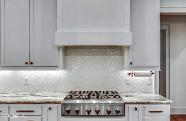 102 Silverleaf Dr, Madison, MS 39110 - kitchen featuring stainless steel gas stovetop, custom range hood, decorative backsplash, and light stone counters