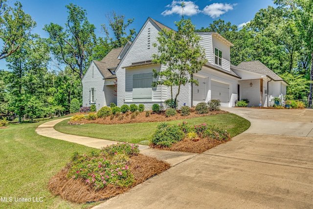 102 Silverleaf Dr, Madison, MS 39110 - view of front of house with an attached garage, concrete driveway, a front yard, brick siding, and roof with shingles