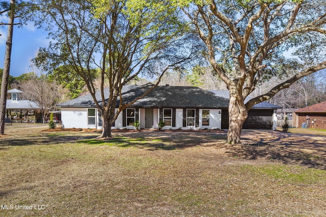 single story home featuring a garage and a front lawn