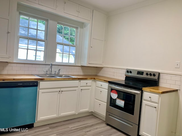 kitchen with white cabinetry, light wood-type flooring, sink, stainless steel appliances, and butcher block countertops