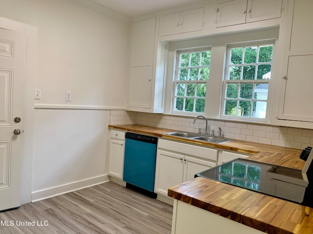 kitchen featuring dishwasher, butcher block counters, decorative backsplash, sink, and white cabinets