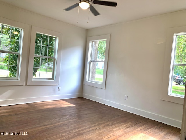 empty room featuring ornamental molding, dark hardwood / wood-style floors, and ceiling fan