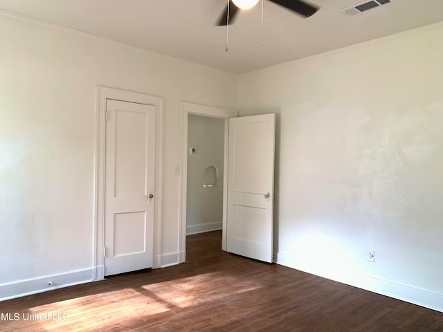 unfurnished room with ornamental molding, ceiling fan, and dark hardwood / wood-style flooring