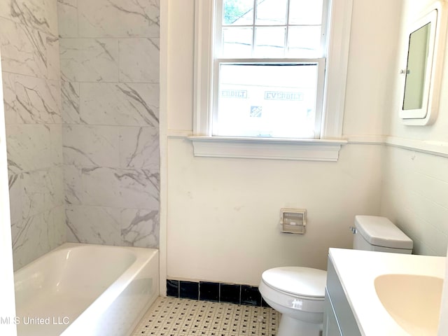 bathroom featuring vanity, a bathtub, and toilet