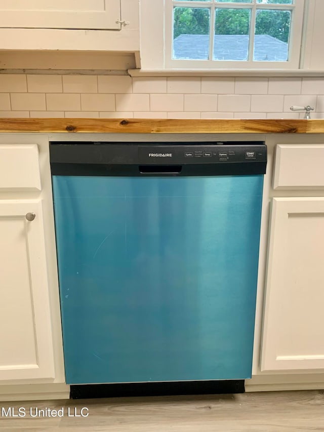 details featuring decorative backsplash, light hardwood / wood-style flooring, white cabinets, stainless steel dishwasher, and butcher block countertops