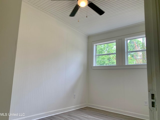 empty room featuring ornamental molding, hardwood / wood-style flooring, and ceiling fan