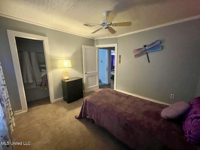 carpeted bedroom featuring a textured ceiling, a closet, ceiling fan, and ornamental molding