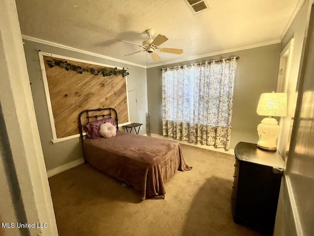 carpeted bedroom with a textured ceiling, ceiling fan, and ornamental molding