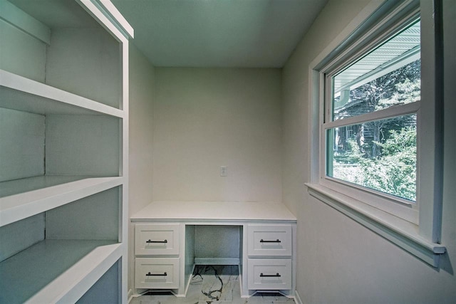 home office featuring marble finish floor and built in study area