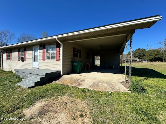 view of front of house with a carport, driveway, and a front lawn