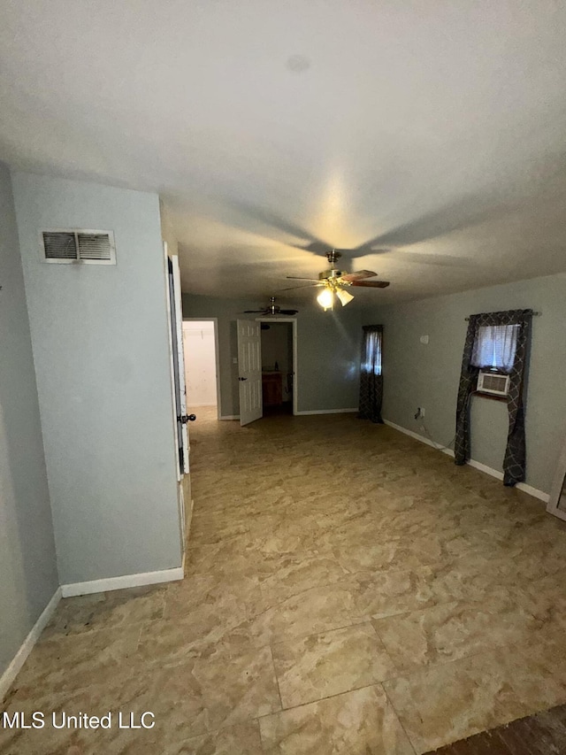 unfurnished living room with baseboards, visible vents, and a ceiling fan