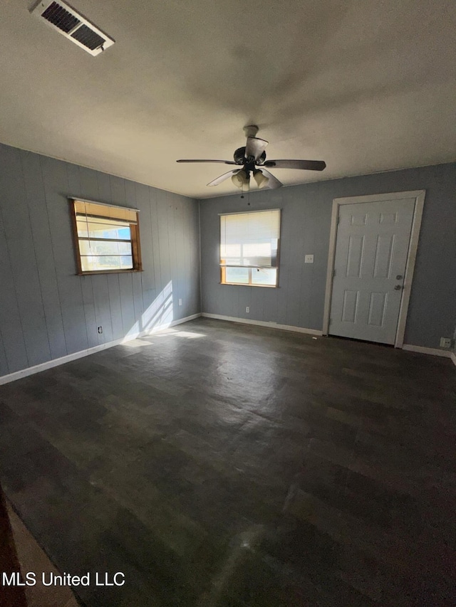 unfurnished room with visible vents, ceiling fan, and baseboards