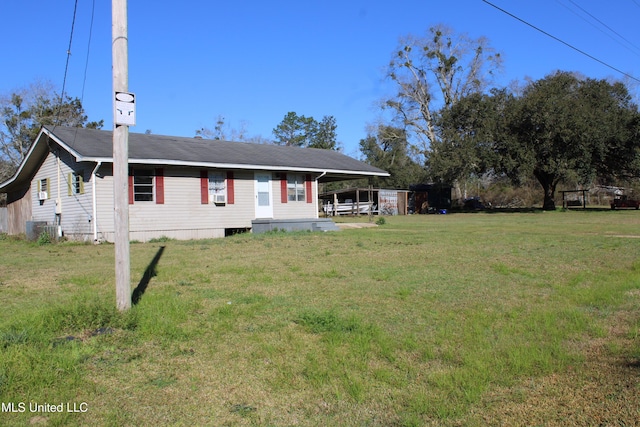 view of front of property with a front lawn and central AC