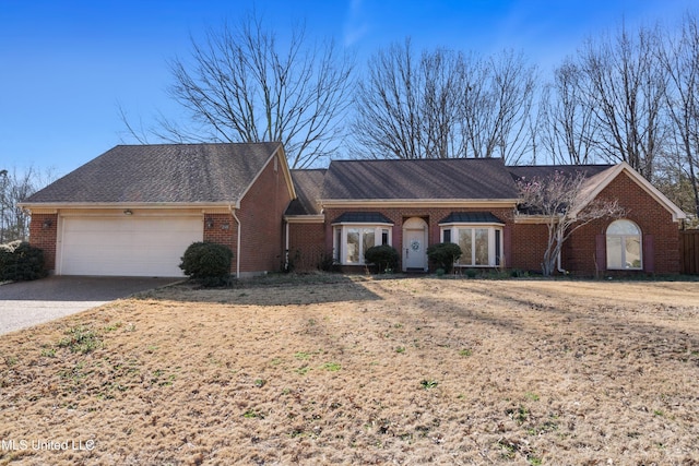 ranch-style house featuring concrete driveway, an attached garage, brick siding, and a shingled roof