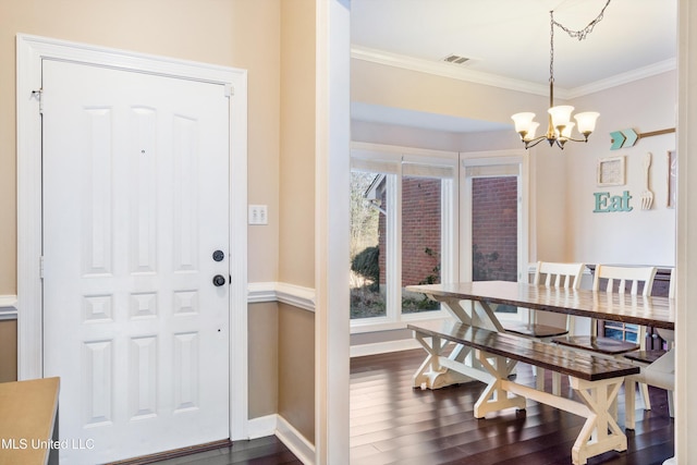 interior space featuring visible vents, crown molding, baseboards, a notable chandelier, and dark wood-style flooring